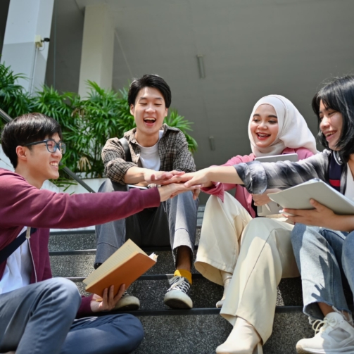 group-of-university-students-stacking-hands-celeb-2023-11-27-05-32-21-utc-scaled