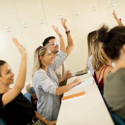 university-srudents-in-the-classroom-with-hands-ra-2025-02-22-05-02-32-utc-scaled