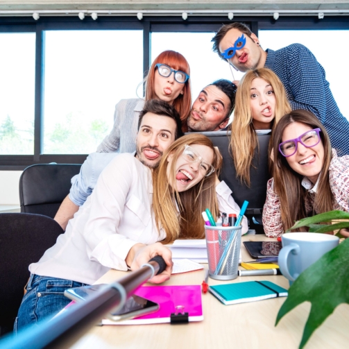 young-people-employee-workers-taking-happy-selfie-2024-07-03-02-44-12-utc-scaled